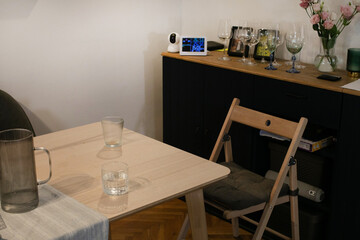 A cozy nook with mismatched glassware, hinting at clandestine gatherings for Obon ritual or circadian rhythm conspiracy