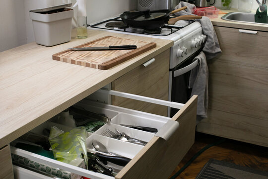 Cozy kitchen's open drawer chaos whispers tales of culinary adventures, echoing Festival of Chefs and Global Kitchen Day