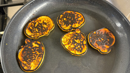 Crispy, charred golden pancakes sizzle energetically in the pan, evoking Shrove Tuesday culinary mishaps and kitchen alchemy mysteries