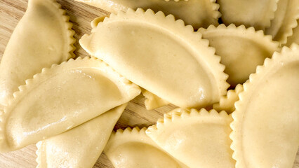 Golden half-moon dumplings embrace rustic charm, evoking Eastern European culinary traditions and...