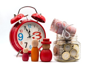 5,000 Kazakhstani tenge banknotes and a glass jar with 100 tenge coins on a white background