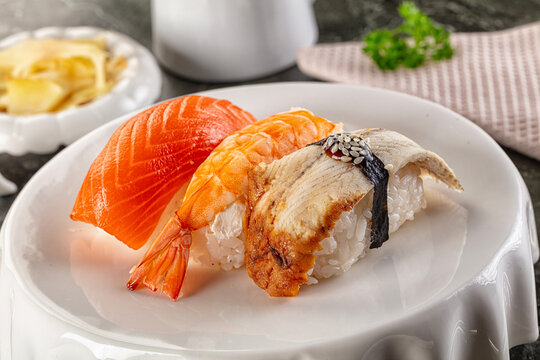 Japanese cuisine - sushi with eel, salmon and prawn - Powered by Adobe