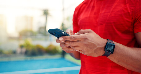Hands, man and typing with phone on tennis court with fitness app, training tips and track progress. Person, mobile and reservation for padel, technique and video demonstration for sports tournament
