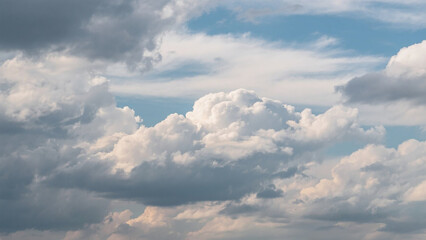 Fototapeta premium Layered Cloudscape with Bright Cumulus and Dark Stratus