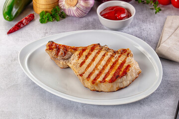 Tasty hot grilled bone steak served sauce
