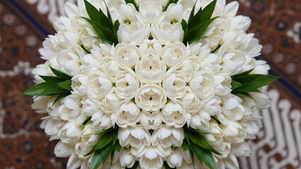 Exclusive bouquet made of Javanese jasmine flowers with green leaf accents