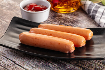 Boiled sausages with ketchup