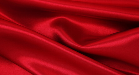 Smooth elegant red silk or satin luxury cloth texture as abstract background. Luxurious valentines day background design