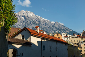 Alpine Town with Red Roofs and Snowy Mountain Peaks under Clear Blue Sky
