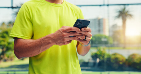 Cellphone, fitness and hands of man on court with networking, communication or texting on mobile app. Technology, sports and male athlete with typing on phone for chatting, contact or social media.