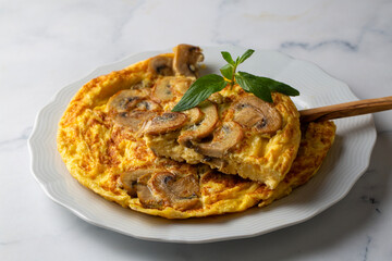 Frittata is an Italian type of omelet. Omelet with mushrooms cast-iron pan.
