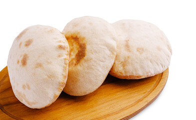 Fresh pita bread on wooden platter ready for serving with dips