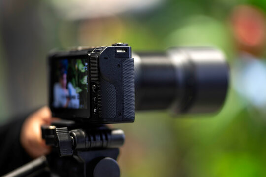 Doha, Qatar - November 05, 2025:  Nikon ZR series mirrorless camera mounted on a tripod and recording a video in an outdoor setting.