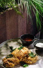 Delicious fried dishes served with dipping sauces on a rustic table