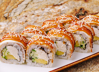 Delicious sushi rolls with creamy filling presented on a white plate
