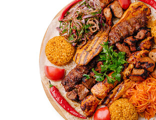 Delicious mixed grill platter featuring meats, rice, and fresh vegetables