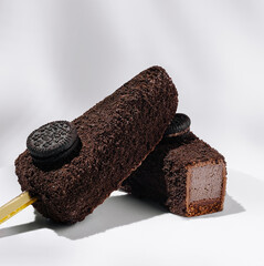 Delicious chocolate ice cream bars with cookie topping on a light background