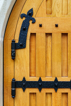 close up view of old wooden door made of planks and metal decorative elements as background