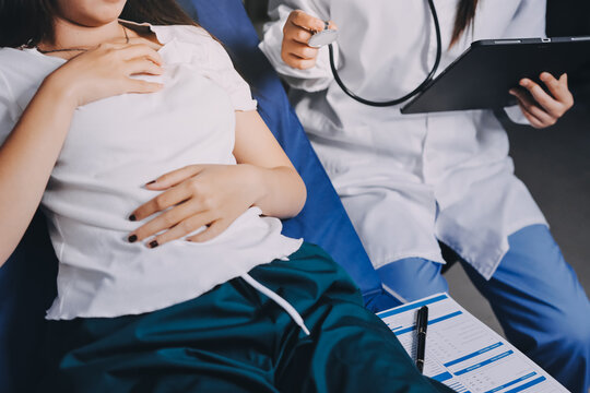 Doctor examining patient with stethoscope in hospital bed. Medical care and healthcare concept in a clinical setting. - Powered by Adobe
