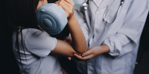 old woman training with physiotherapist using dumbbells at home therapist assisting senior woman...