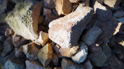 Natural golden-hued river rocks with smooth texture for landscaping and garden decoration