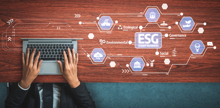 A professional workspace showcases hands typing on a laptop surrounded by icons representing ESG principles, highlighting sustainable business strategies and innovation. Tessel