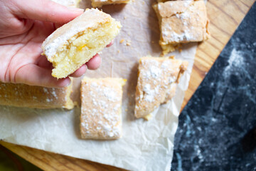 Close-up of a woman’s hand holding a freshly baked cookie. Homemade dessert, sweet snack, baking theme and cozy kitchen atmosphere.