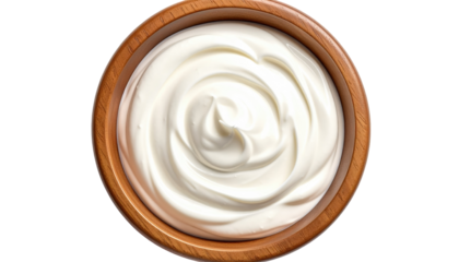 Overhead shot of a wooden bowl filled with creamy, white dairy product, swirling to create a pleasant spiral pattern