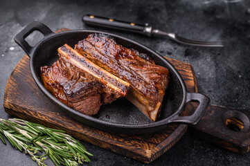Gourmet grilled short ribs on a dark background with plenty of negative space for custom text or design.