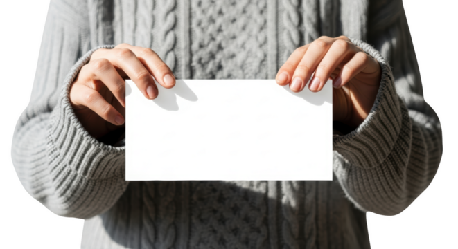 Person wearing gray cable knit sweater holding blank white card isolated on a transparent background - Powered by Adobe