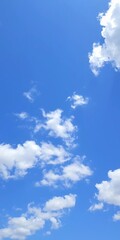 Bright blue sky with scattered white clouds on a sunny day,  daylight,  blue