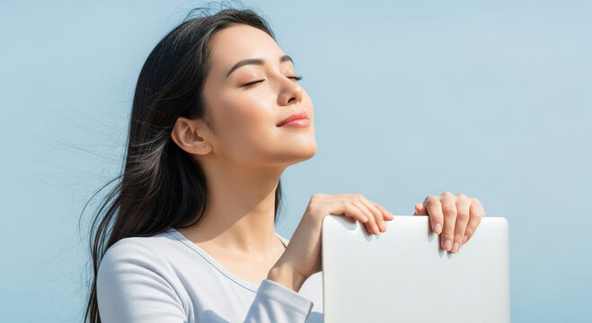 Young woman enjoying a moment of peace and fresh air outdoors with a laptop