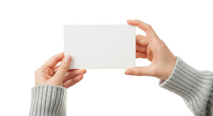 Two hands holding a blank white rectangular card with a grey knitted sweater sleeve isolated on a transparent background