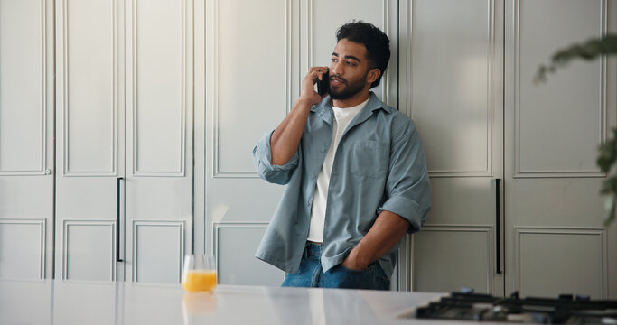 Man, student and relax with phone call at house for discussion, study schedule and feedback. Male person, mobile and juice to contact college for enrolment, education consultation and admission chat
