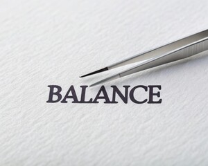 Tweezers Holding Word Balance on Clean Surface