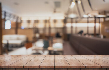 Empty wooden table top with lights bokeh on blur restaurant background.