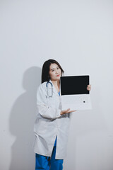 Female druggist standing with a digital tablet