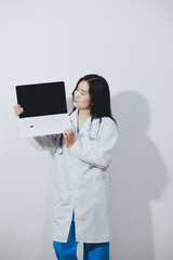 Female druggist standing with a digital tablet