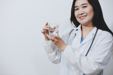 Portrait of Asian doctor woman standing holding coffee cup in white studio background
