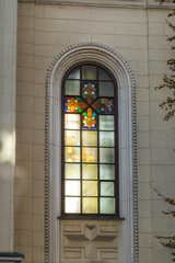 Ornate arched windows with stained glass crosses on cistoric facade, Evangelical Church Community of Ljubljana