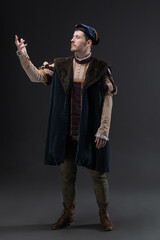 Romano, a romantic hero of a medieval setting, a young man in a costume from the early Renaissance or the Middle Ages, a theatrical or cinematic image, a cape and beret, brocade clothes, an aristocrat