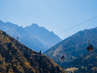Layered Kazakh wilderness: distant peaks, green foothills and vast steppe grasslands.