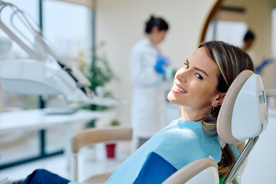 Young female patient feeling good during a dental check-up in a comfortable chair at a contemporary dentistry office - Powered by Adobe