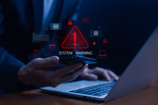 A businessman is using a laptop with a cybersecurity alert warning on the screen, preventing cyber threats in systems and digital environments. data systems warning, fraud. danger cyber attack