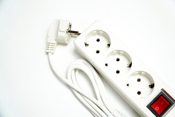 Power Strip with Switch: Multi-Socket Outlet for Electrical Appliances. White 4 hole socket ( stop contact) with brown wood background. Close-up of Electrical Cables with Exposed Copper Wires on White