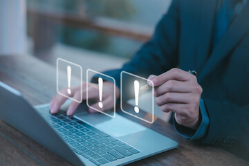 The businessman's hand shows a white exclamation mark. business development concept, error warning, notification, maintenance, and finding a solution. dark background with copy space