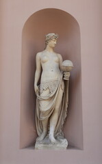 Commodities Exchange Building Exterior Detail with Statue of a Woman Holding a Globe in Trieste, Italy