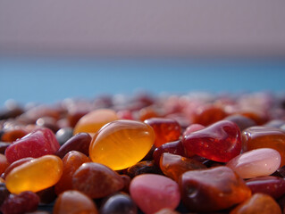 Colorful polished stones reflecting light on a blurred background texture perfect for artistic projects or zen like compositions