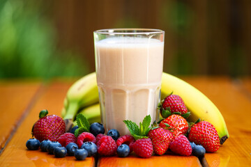 Healthy Smoothie with Fresh Berries and Banana on a Wooden Table for a Nutritious Breakfast