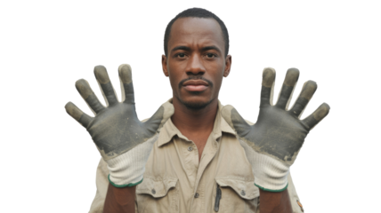 A serious Black man wearing work gloves holds up both hands, looking directly at the camera against a transparent background. background removed